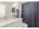 Bright bathroom featuring granite counters, modern lighting, and a gray shower curtain at 5913 E Thomas Rd, Scottsdale, AZ 85251