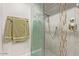 Shower with glass door and gray tiled walls at 5913 E Thomas Rd, Scottsdale, AZ 85251