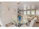 This dining room features a modern glass table, comfortable seating, and an open floor plan to the living area at 5913 E Thomas Rd, Scottsdale, AZ 85251