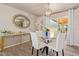 Dining room with glass table, white chairs, and modern light fixture at 5913 E Thomas Rd, Scottsdale, AZ 85251