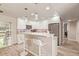 Bright kitchen features white cabinets, granite countertops, stainless appliances, and breakfast bar with stylish pendant lights at 5913 E Thomas Rd, Scottsdale, AZ 85251