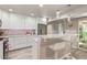 This updated kitchen features modern white cabinets, stainless steel appliances, and a breakfast bar with seating at 5913 E Thomas Rd, Scottsdale, AZ 85251