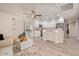 Bright, open-concept living space showcasing wood-look tile floors, recessed lighting, and a view into the kitchen at 5913 E Thomas Rd, Scottsdale, AZ 85251