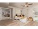 Cozy living room featuring wood-look floors, a ceiling fan, and stylish decor at 5913 E Thomas Rd, Scottsdale, AZ 85251