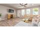 Comfortable living room with wood-look floors, ample natural light, and a cozy sofa, perfect for relaxation at 5913 E Thomas Rd, Scottsdale, AZ 85251
