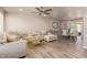 Bright living room featuring a large sofa, ceiling fan, and wood flooring at 5913 E Thomas Rd, Scottsdale, AZ 85251
