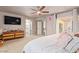 Primary bedroom with en suite bathroom, television, and backyard access at 5913 E Thomas Rd, Scottsdale, AZ 85251