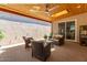 Relaxing covered patio with ceiling fan, skylight, and outdoor seating, perfect for entertaining and enjoying the outdoors at 5913 E Thomas Rd, Scottsdale, AZ 85251