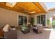 Relaxing covered patio with a wood ceiling, a ceiling fan, and comfortable wicker furniture at 5913 E Thomas Rd, Scottsdale, AZ 85251