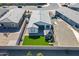 A high-angle image features a fenced yard, a patio, artificial grass, and a covered seating area with lounge chairs at 6117 S Adelle --, Mesa, AZ 85212