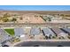 An aerial view showing homes, manicured lawns and the surrounding desert landscape in the distance at 6117 S Adelle --, Mesa, AZ 85212