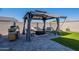 Relaxing backyard featuring a gazebo with outdoor seating, a grill, and lush artificial turf, great for entertaining at 6117 S Adelle --, Mesa, AZ 85212