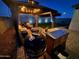 Beautifully lit backyard at night showcasing a gazebo with string lights and a barbecue station, perfect for outdoor dining at 6117 S Adelle --, Mesa, AZ 85212