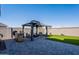 Beautiful backyard featuring a charming gazebo with seating and a well-maintained artificial turf lawn at 6117 S Adelle --, Mesa, AZ 85212