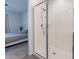 Shower room with a glass enclosure, alongside a decorative bedroom at 6117 S Adelle --, Mesa, AZ 85212