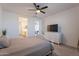 Bedroom with a ceiling fan, decorative headboard, easy access to the en suite bathroom and other areas of the home at 6117 S Adelle --, Mesa, AZ 85212
