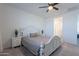 Bright bedroom featuring a ceiling fan, decorative headboard, and easy access to other areas of the home at 6117 S Adelle --, Mesa, AZ 85212