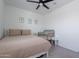 Comfortable bedroom with a ceiling fan, soft neutral bedding, and charming decor at 6117 S Adelle --, Mesa, AZ 85212