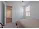 A bright bedroom with neutral walls and carpet plus closet and view into the hallway at 6117 S Adelle --, Mesa, AZ 85212