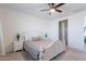 Bright bedroom featuring a ceiling fan, decorative headboard, and easy access to other areas of the home at 6117 S Adelle --, Mesa, AZ 85212