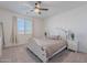 Inviting bedroom with a decorative bed frame, bedside tables, and a window with soft curtains at 6117 S Adelle --, Mesa, AZ 85212