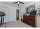 Carpeted bedroom featuring elephant art, dresser, weightlifting equipment, and ceiling fan at 6117 S Adelle --, Mesa, AZ 85212