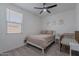 Bright bedroom featuring a bed with neutral bedding, a ceiling fan, and a baby's crib at 6117 S Adelle --, Mesa, AZ 85212