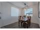 Bright dining room features a wooden table, seating for six, and views of the backyard at 6117 S Adelle --, Mesa, AZ 85212