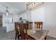 Open dining space showcasing a wooden table, chairs, and a pendant light fixture above the table at 6117 S Adelle --, Mesa, AZ 85212