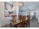 Dining area with dark wood table and decorative art with connecting view of the kitchen at 6117 S Adelle --, Mesa, AZ 85212