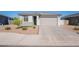 Lovely single-story home showcasing a paved driveway and desert landscaping, offering a blend of style and low maintenance at 6117 S Adelle --, Mesa, AZ 85212