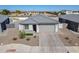 A charming home featuring a well-kept front yard and a paved driveway leading to the garage at 6117 S Adelle --, Mesa, AZ 85212