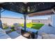 Relaxing gazebo with plush seating overlooking a lush artificial turf lawn, perfect for outdoor leisure and entertaining at 6117 S Adelle --, Mesa, AZ 85212