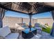 Cozy gazebo featuring comfortable seating, perfect for relaxing outdoors, complemented by a neat artificial turf lawn at 6117 S Adelle --, Mesa, AZ 85212
