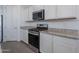 Modern kitchen features stainless steel appliances, granite countertops, and stylish cabinetry, designed for functionality and aesthetics at 6117 S Adelle --, Mesa, AZ 85212