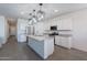 A modern kitchen with granite countertops, stainless steel appliances, and stylish lighting fixtures at 6117 S Adelle --, Mesa, AZ 85212