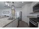 Close-up of a kitchen island with stainless steel appliances and granite countertops at 6117 S Adelle --, Mesa, AZ 85212