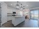 Bright, open kitchen featuring a large center island, granite countertops, and stainless steel appliances at 6117 S Adelle --, Mesa, AZ 85212