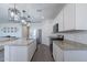 Open-concept kitchen with an island, stainless steel appliances, granite countertops, and modern lighting, perfect for entertaining at 6117 S Adelle --, Mesa, AZ 85212