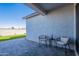 Cozy patio featuring two chairs, a side table, a gray brick surface, and synthetic grass at 6117 S Adelle --, Mesa, AZ 85212