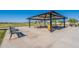 Community pavilion with tables and benches for outdoor enjoyment and neighborhood gatherings at 6117 S Adelle --, Mesa, AZ 85212