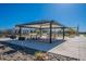A community picnic area with a ramada, tables, benches, and a barbecue grill at 6117 S Adelle --, Mesa, AZ 85212