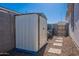 Features a well-maintained shed, perfect for storage with a stone walkway on a sunny day at 6117 S Adelle --, Mesa, AZ 85212