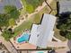 Expansive backyard with a sparkling pool, lush landscaping, and privacy fencing at 7042 N 13Th St, Phoenix, AZ 85020