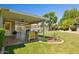 Spacious backyard featuring a covered patio, well-maintained lawn, and ample space for outdoor enjoyment at 7042 N 13Th St, Phoenix, AZ 85020