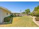 Expansive backyard featuring a covered patio, lush lawn, and colorful flowerbeds at 7042 N 13Th St, Phoenix, AZ 85020