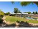 Spacious backyard with a fenced-in swimming pool and lush lawn, perfect for outdoor entertaining at 7042 N 13Th St, Phoenix, AZ 85020