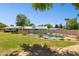 Fenced backyard showcases a sparkling pool, patio, and lush landscaping, perfect for relaxation and recreation at 7042 N 13Th St, Phoenix, AZ 85020