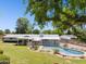 Beautiful backyard featuring a sparkling pool, a covered patio, and well-maintained landscaping at 7042 N 13Th St, Phoenix, AZ 85020