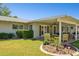 Inviting backyard with a covered patio, lush green lawn, and colorful flowerbeds at 7042 N 13Th St, Phoenix, AZ 85020